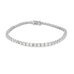 Tennis bracelet east to west style in 18K WG with basket prong set (56) emerald cut diamonds.  D5.70ct.t.w.
