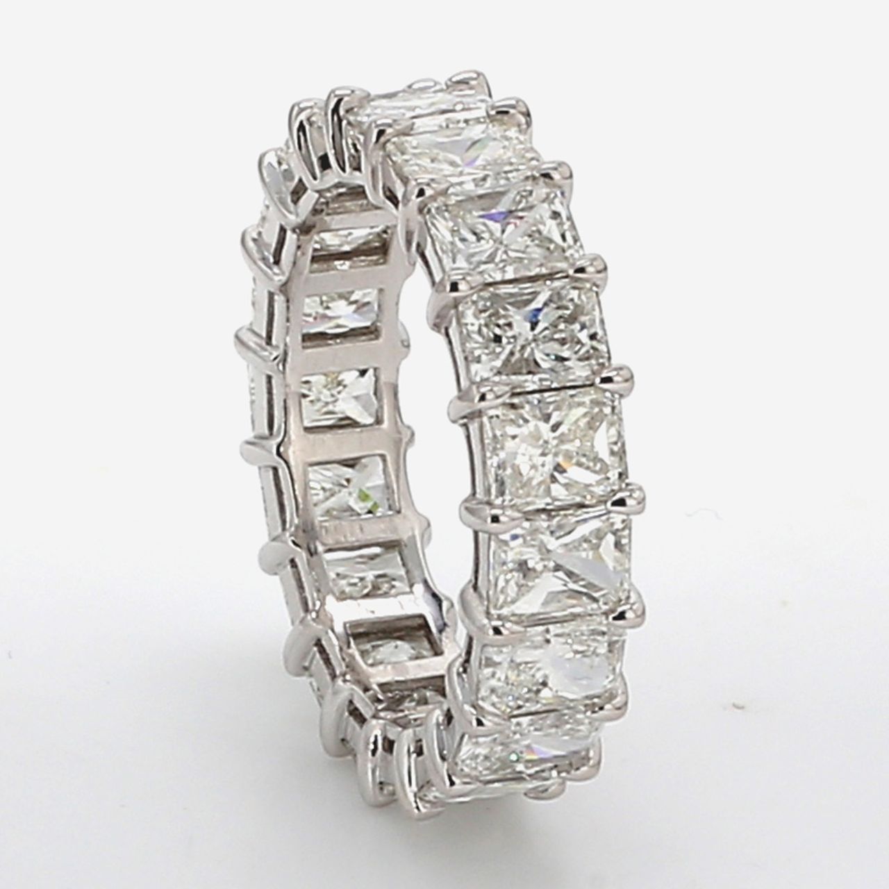 Eternity band in platinum w/ basket claw prong set (19) radiant cut diamonds.  D5.98ct.t.w.  Size 6.25