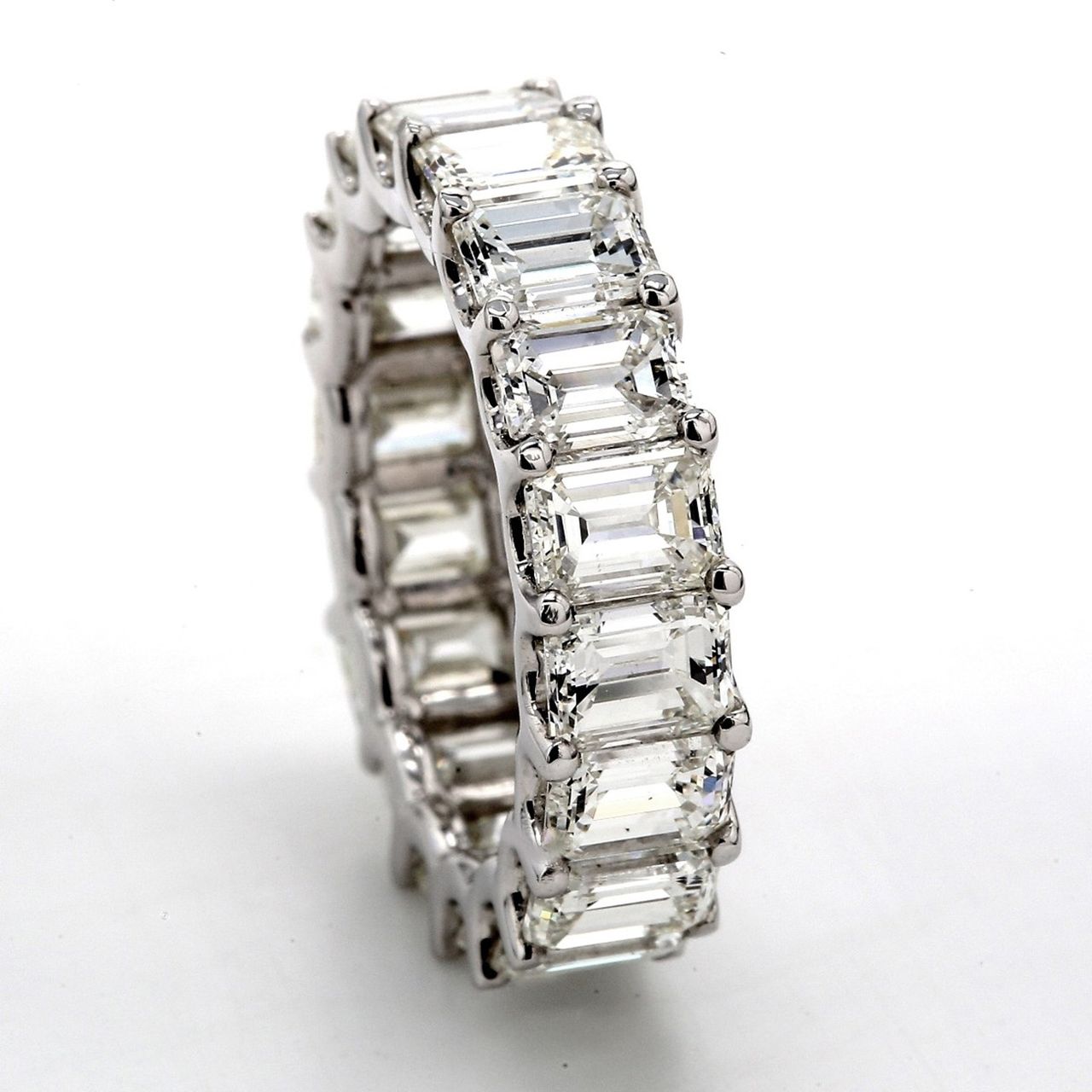 Eternity band in platinum with shared U-prong set (26) emerald cut diamonds.  D3.68ct.t.w.  Size 6