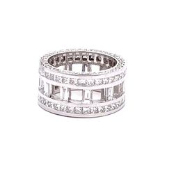 Wide eternity band w/ open channel set baguettes on the inside, channel set princess cuts on the outside, & pave set  round diamonds on the shank.  D6.16ct.t.w.