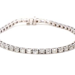 7' Tennis bracelet east to west style in 18K WG with basket prong set (47) emerald cut diamonds.  D5.56ct.t.w.