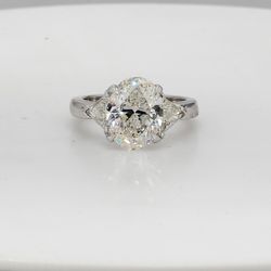 3-stone semi-mount in platinum with claw prong set trilliant cut diamond sides.  D0.69ct.t.w.