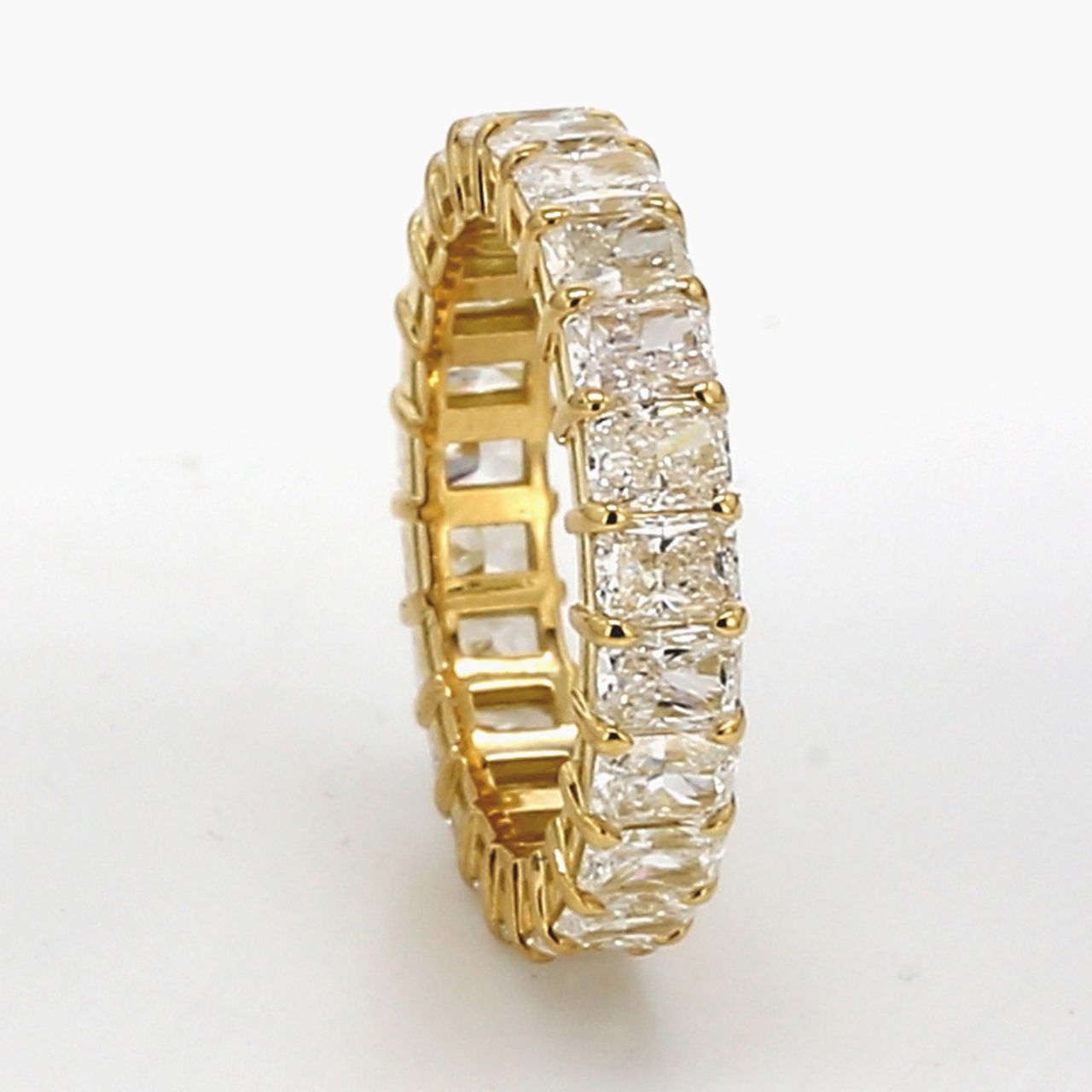Eternity band in 18K YG with basket prong set (23) radiant cut diamonds.  D1.73ct.t.w.  Size 5