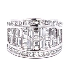 Band in 10L WG invisible set baguettes and channel set princess cut diamonds on the sides.  D3.68ct.t.w.  Size 5.5