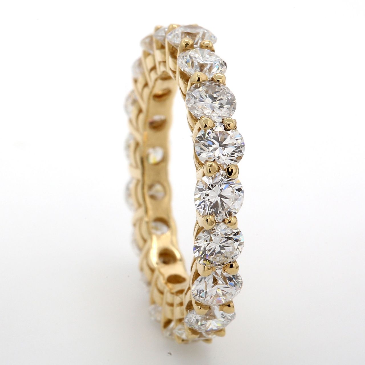 Eternity band in 14K YG with shared prong set (19) round diamonds.  D3.30ct.t.w.  Size 5