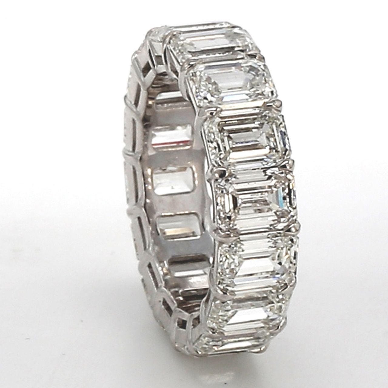 Eternity band in platinum with basket prong set GIA certified G-I/VVS-VS (16) emerald cut diamonds.  D8.12ct.t.w.  Size 4.75