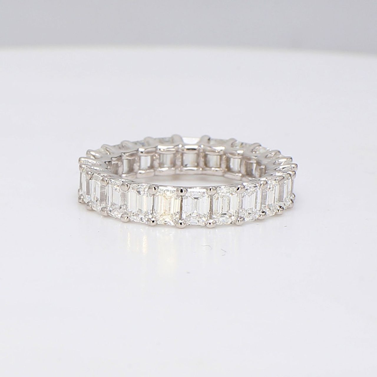 Eternity band in platinum with U-prong set (23) emerald cut diamonds.  D4.32ct.t.w.  Size 6.75