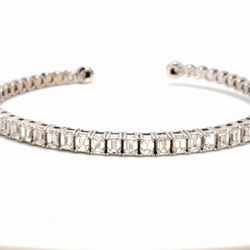 Open cuff bangle in 18K WG with basket prong set (26) emerald cut diamonds.  D3.89ct.t.w.