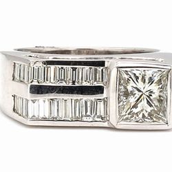 Flat top ring in 18K WG w/ 2-row channel set baguettes & princess cut diamond center stone.  D4.73ct.t.w.  (Center - 2.23ct.)