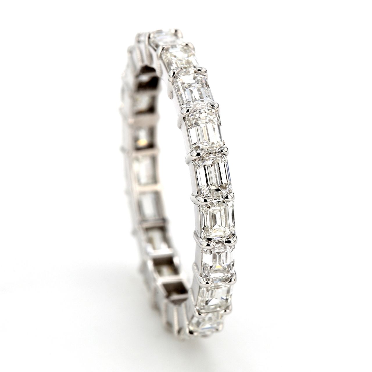 East to west style eternity band with shared prong basket set emerald cut diamonds.  D2.88ct.t.w.  Size 6.75