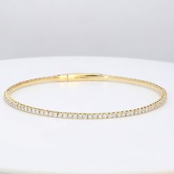 7' Lightweight flexible oval Bangle with prong set round diamonds.  D1.04ct.t.w.