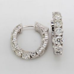0.75' Oval shaped inside out hoop earrings with shared prong set round diamonds.  D5.40ct.t.w.