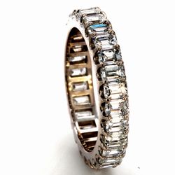 Eternity band in platinum with U-prong set (28) emerald cut diamonds.  D3.05ct.t.w.  Size 6.5