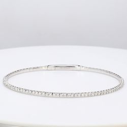 6.5' Lightweight flexible oval bangle in 18K WG with prong set round diamonds.  D1.04ct.t.w.