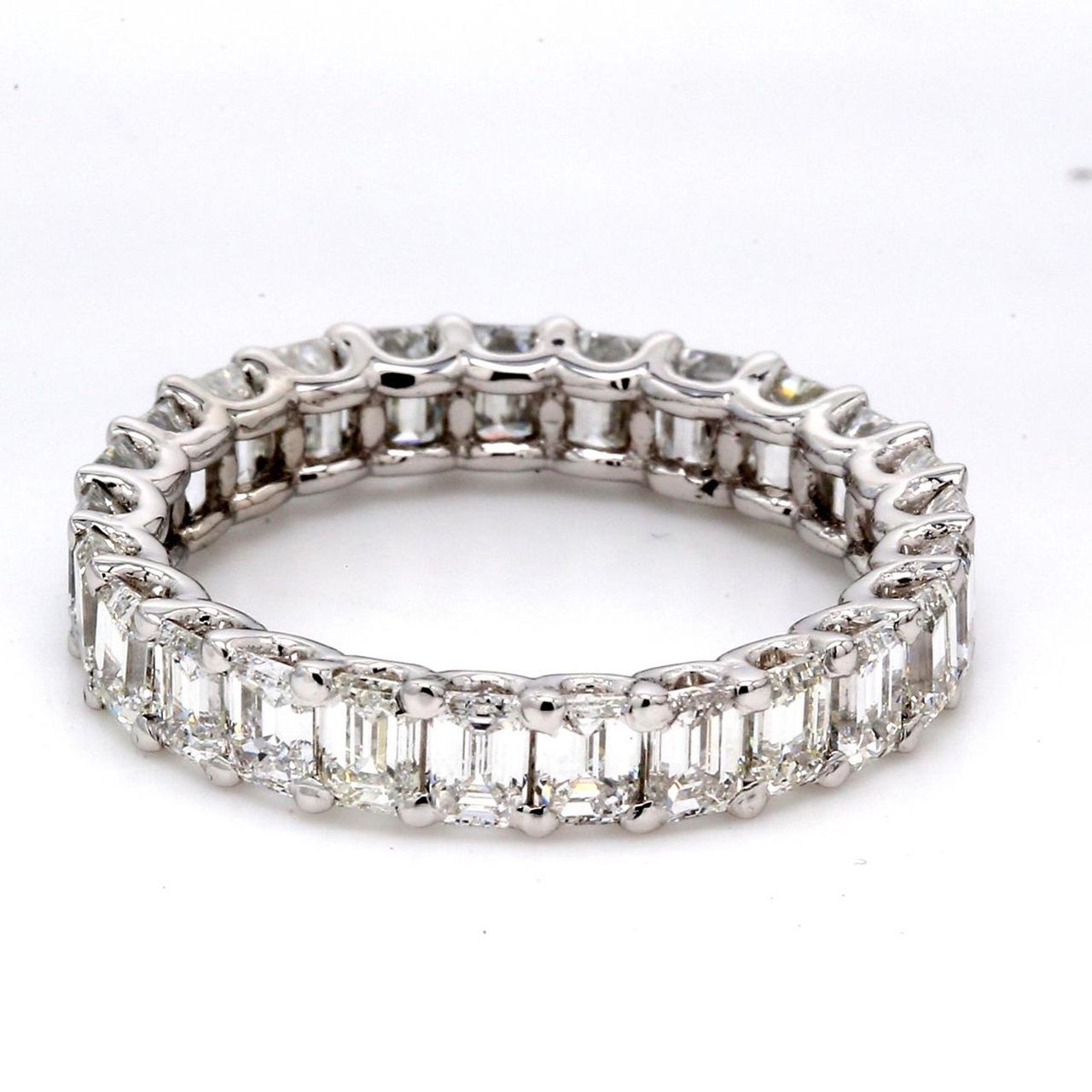 Eternity band in platinum with shared U-prong set emerald cut diamonds.  D4.04ct.t.w.  Size 6.75