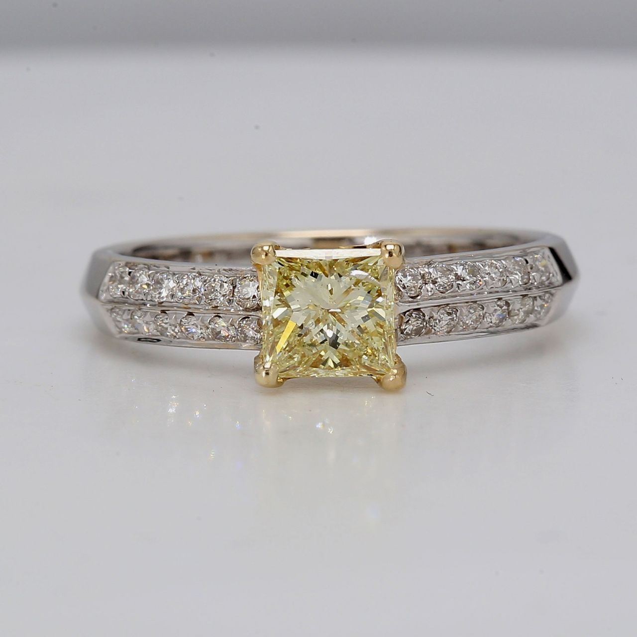 Ring in 18K 2-tone with prong set prong set GIA certified FLY/SI1 princess cut center and 2-row French Pave round diamonds along the shank.   D1.00ct.t.w.  (Center 0.71ct.)