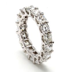 Eternity band in platinum with shared U-prong set cushion cut diamonds.  D5.30ct.t.w.
