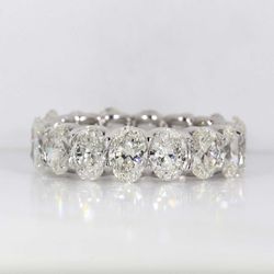 Eternity band in platinum with shared U-prong set GIA certified G-I/VVS2-SI1 (16) oval diamonds.  D6.48ct.t.w.  Size 6