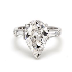 3-stone semi-mount in platinum with channel set tapered baguette diamond sides.  D0.58ct.t.w.  Size 5.5