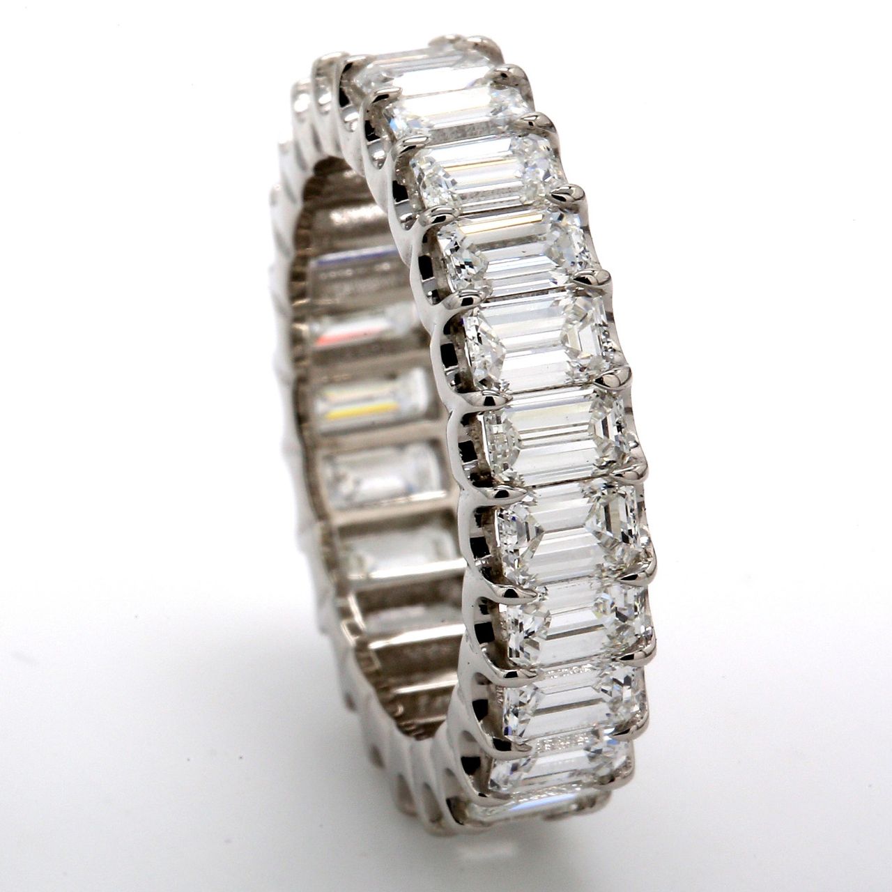 Eternity band in platinum with U-shape prong set (25) emerald cut diamonds.  D5.11ct.t.w.  Size 7