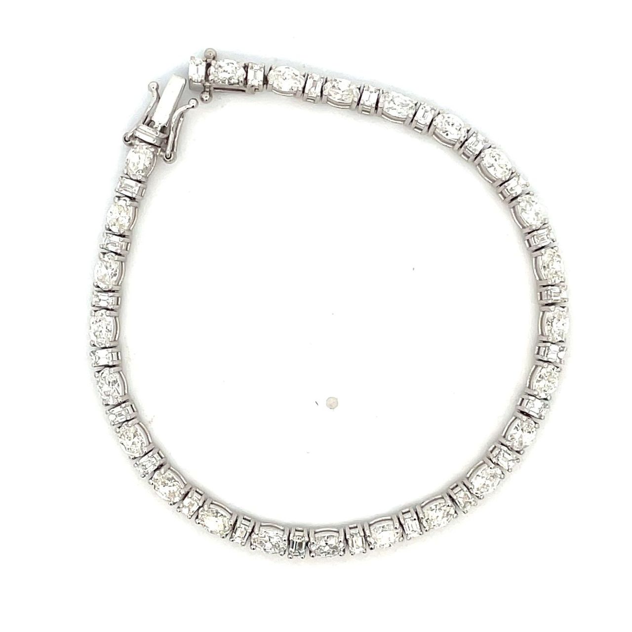Tennis bracelet with basket prong set alternating (24) oval and (24) emerald cut diamonds.  D6.44ct.t.w.