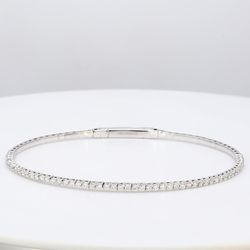6.25' Lightweight flexible oval shaped bangle in 18K WG with prong set round diamonds.  D1.02ct.t.w.