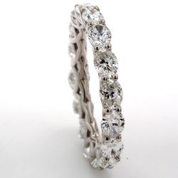 East to west style eternity band in 18K WG with prong set (16) oval diamonds.  D3.36ct.t.w.  Size 6.75