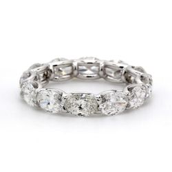 East to west style eternity band in platinum with shared U-prong set (12) oval diamonds.  D3.98ct.t.w.