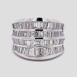 Wide graduated band in 18K WG with 4-row channel set baguette diamonds D3.25ct.tw.  Size 6.75
