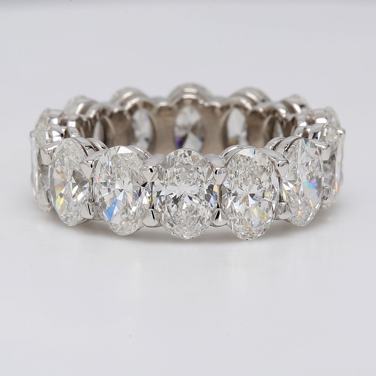 Eternity band in platinum with shared prong basket set GIA certified E-G/SI1-2 (14) oval diamonds.  D9.94ct.t.w.  Size 7
