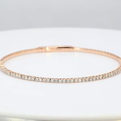 6.50' Lightweight flexible oval bangle in 14K RG with prong set round diamonds.  D1.04ct.t.w.