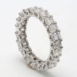 Eternity band in platinum with U-prong set (24) emerald cut diamonds.  D5.04ct.t.w.  Size 7