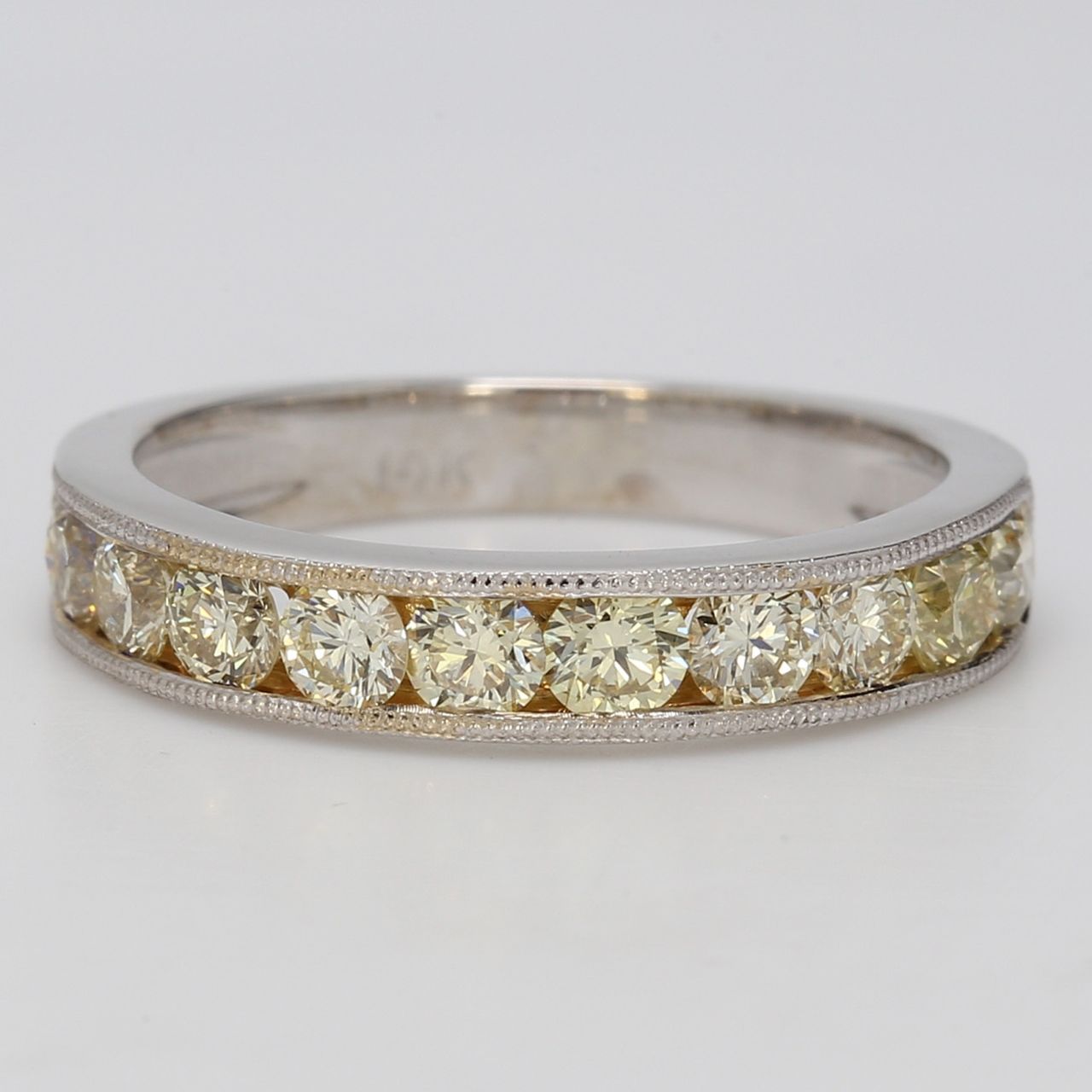 Band with milgrain on the sides & channel set fancy light yellow round diamonds.  D1.65ct.t.w.