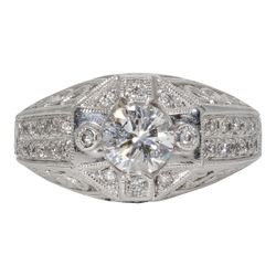 Art deco style ring in 18K WG with engravings and milligrains on the shank, pave set rounds, and prong set round center stone.  D1.31ct.t.w.  (Center 1.01ct.)