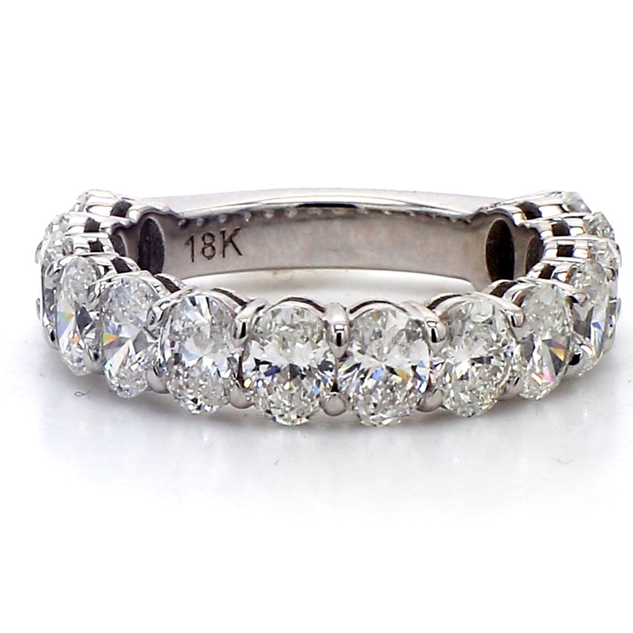 3/4 way band in 18K WG with basket prong set (14) oval cut diamonds.  D2.60ct.t.w.  Size 4.75