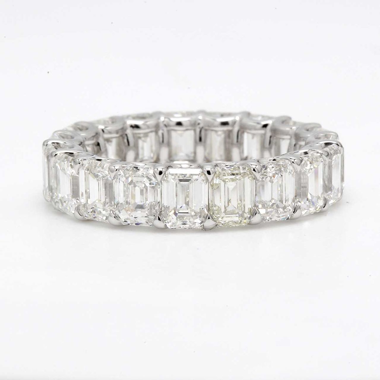 Eternity band in platinum with shared U-prong set (19) emerald cut diamonds.  D5.81ct.t.w.  Size 4.5