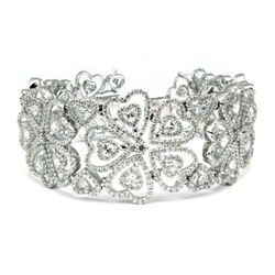 Designer bracelet with heart design in18K WG with prong and pave set round diamonds.  D13.73ct.t.w.