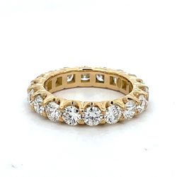 Eternity band in 18K YG with prong set (18) round diamonds.  D3.56ct.t.w.  Size 6.5