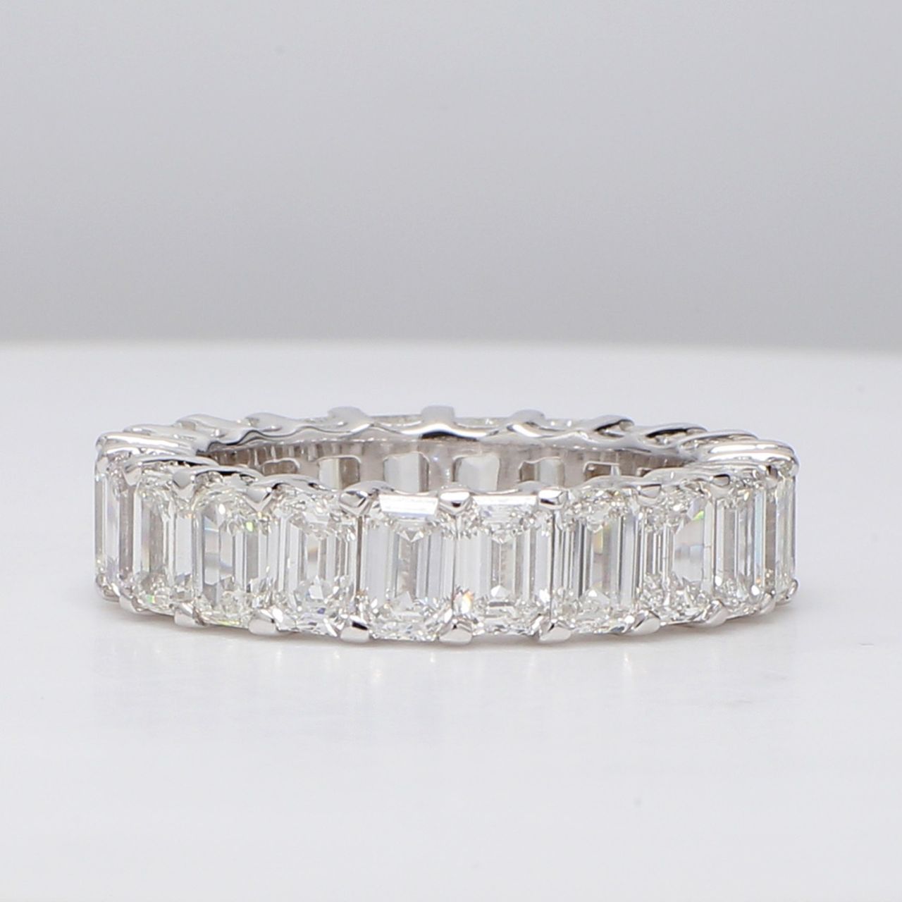 Eternity band with shared prong set (22) emerald cut diamonds.  D7.15ct.t.w.  Size 7