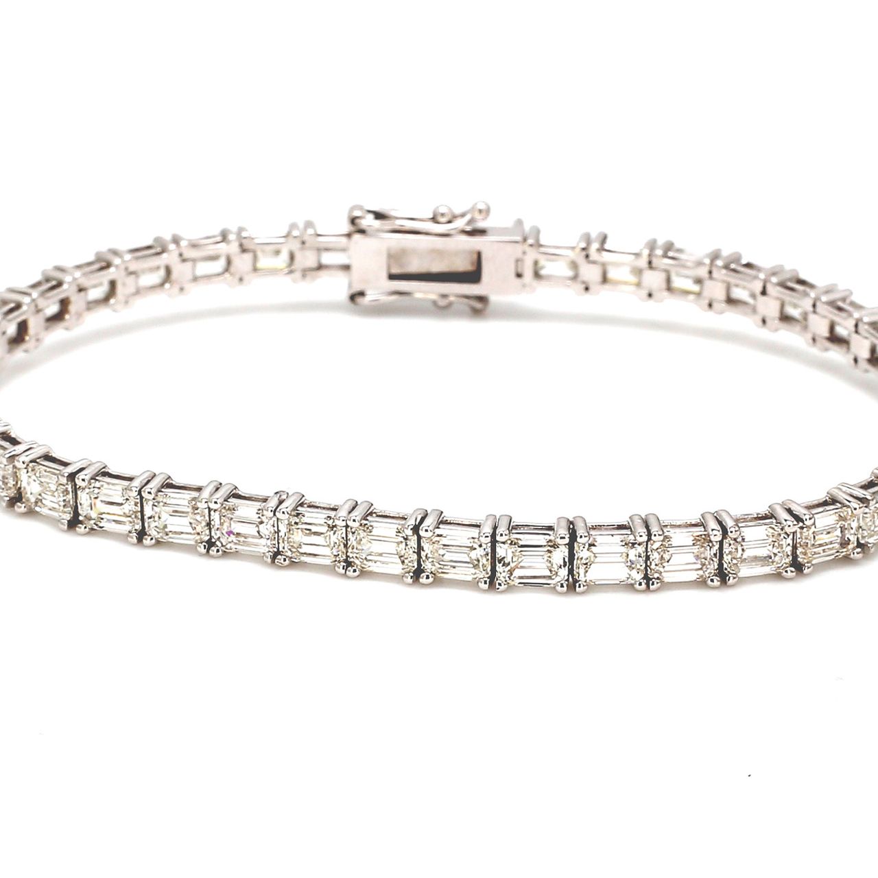 7' Tennis bracelet east to west style with basket prong set (39) emerald cut diamonds.  D11.95ct.t.w.