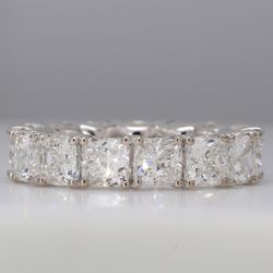 Eternity band in platinum with tulip setting G-H/VS-SI1 (15) cushion cut diamonds.  D7.96ct.t.w.  Size 5.5