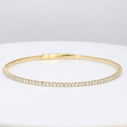 Lightweight flexible oval shaped bangle in 18K YG with prong set round diamonds.  D1.02ct.t.w.