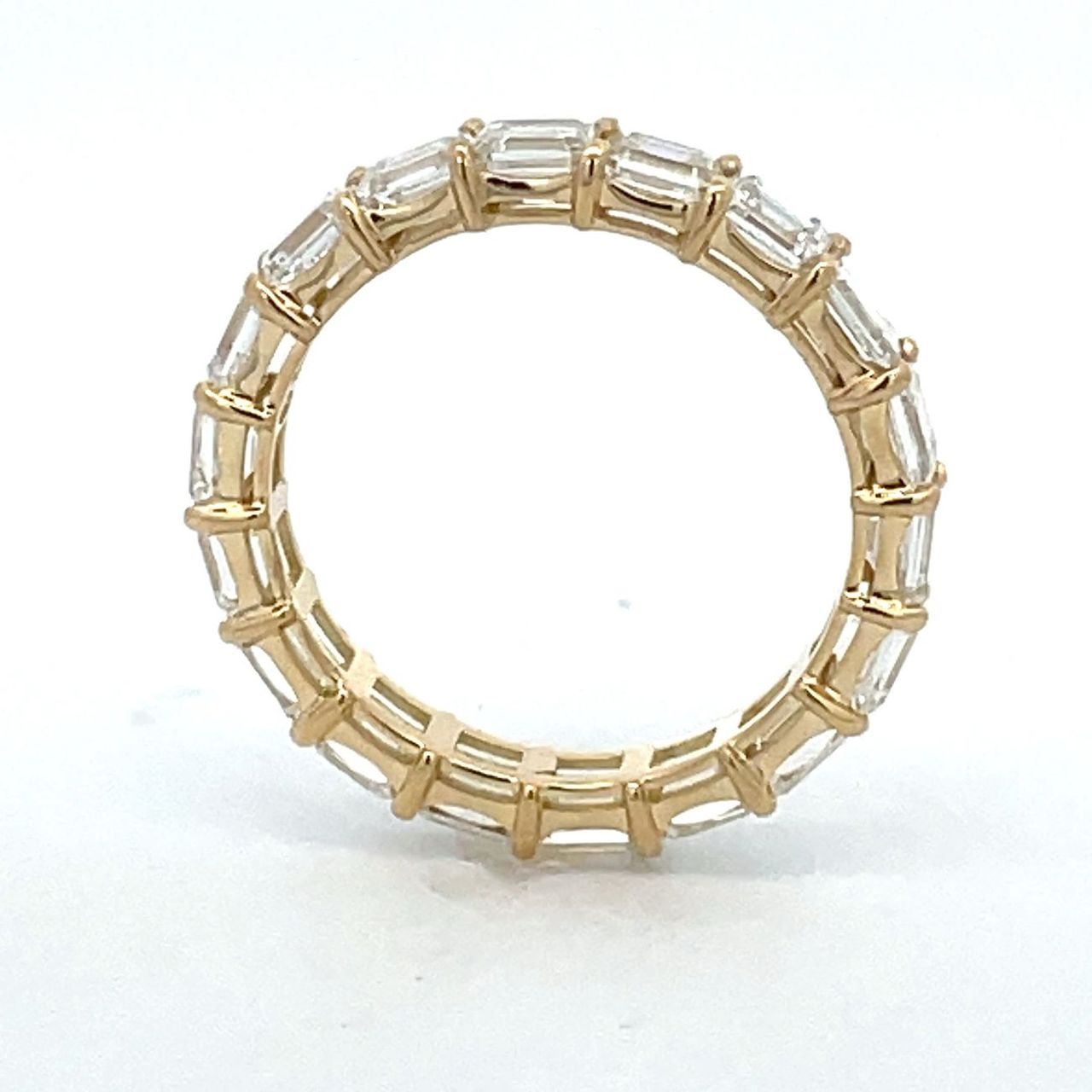 Eternity band east west style in 18K YG with basket prong set (18) emerald cut diamonds.  D2.48ct.t.w.  Size 5