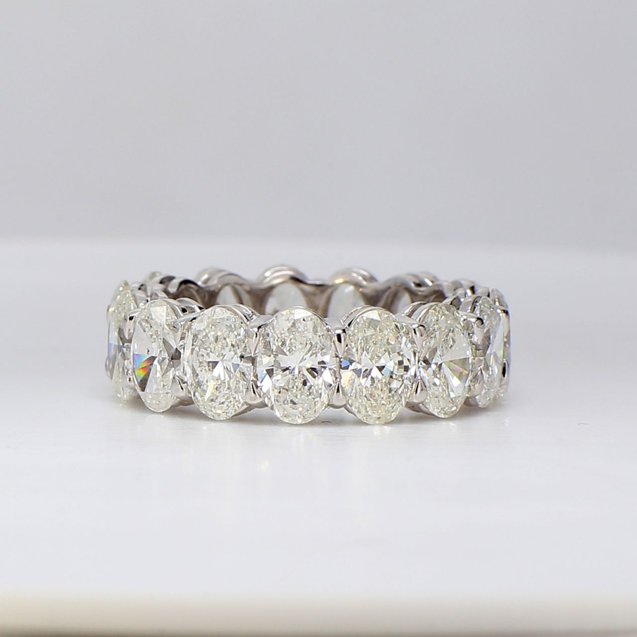 Eternity band in platinum with shared basket prong set G/SI (15) oval diamonds.  D7.74ct.t.w.  Size 6.25