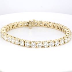 7' Tennis bracelet in 14K YG with 4-prong basket set round diamonds.  D10.69ct.t.w.