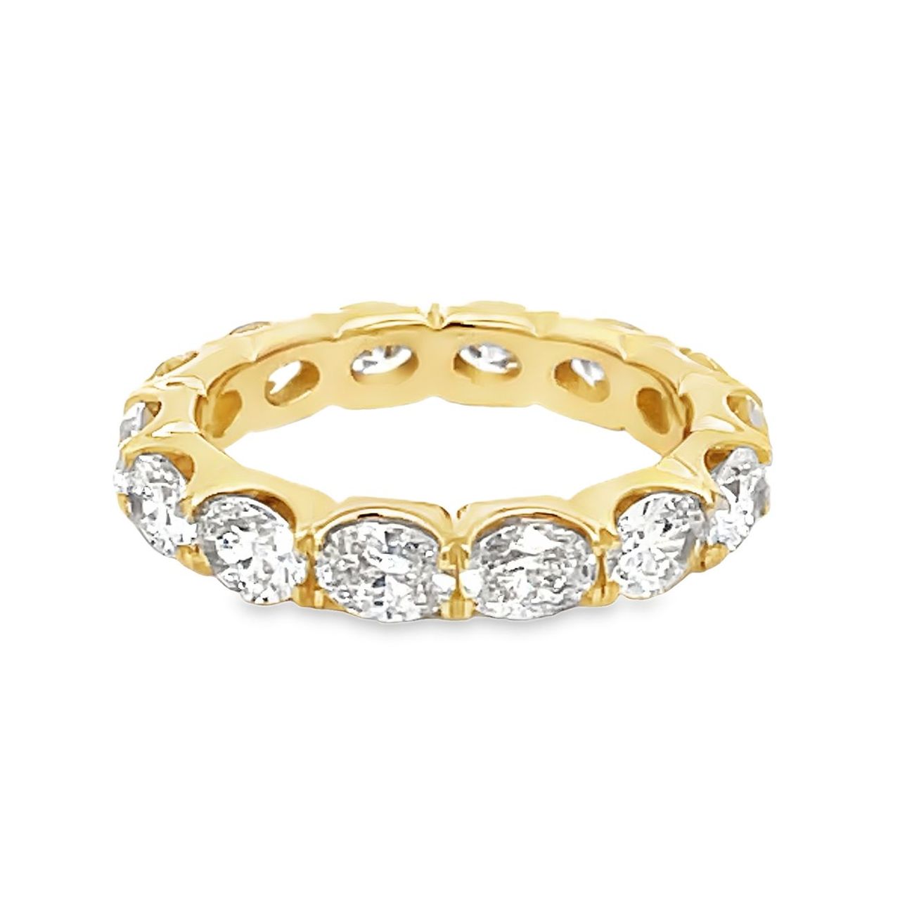 Eternity band east west style in 18K YG with prong set (14) oval diamonds.  D3.33ct.tw.  Size 6.5