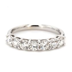 7-stone band with shared basket prong set round diamonds.  D1.06ct.t.w.  Size 7