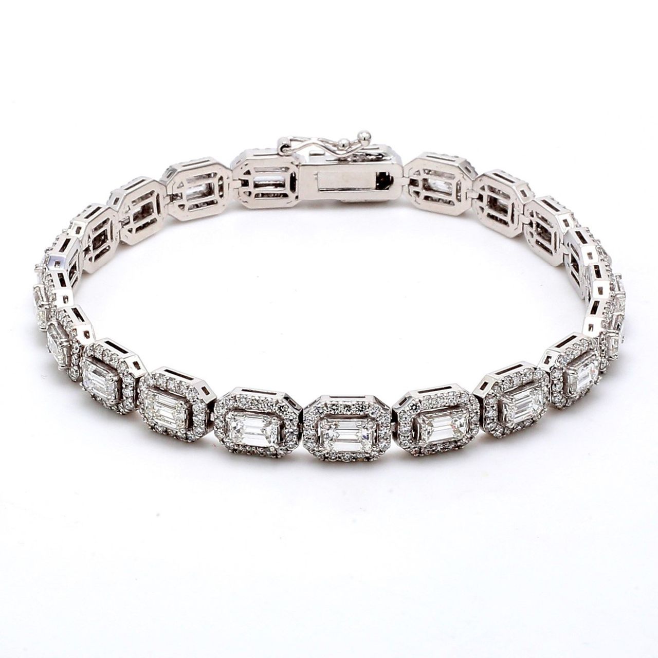 7' Halo bracelet east to west style with pave set rounds around (23) emerald diamond centerstones.  D7.12ct.t.w.