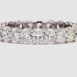Eternity band in platinum with basket prong set (22) oval cut diamonds.  D3.02ct.t.w.  Size 6.5
