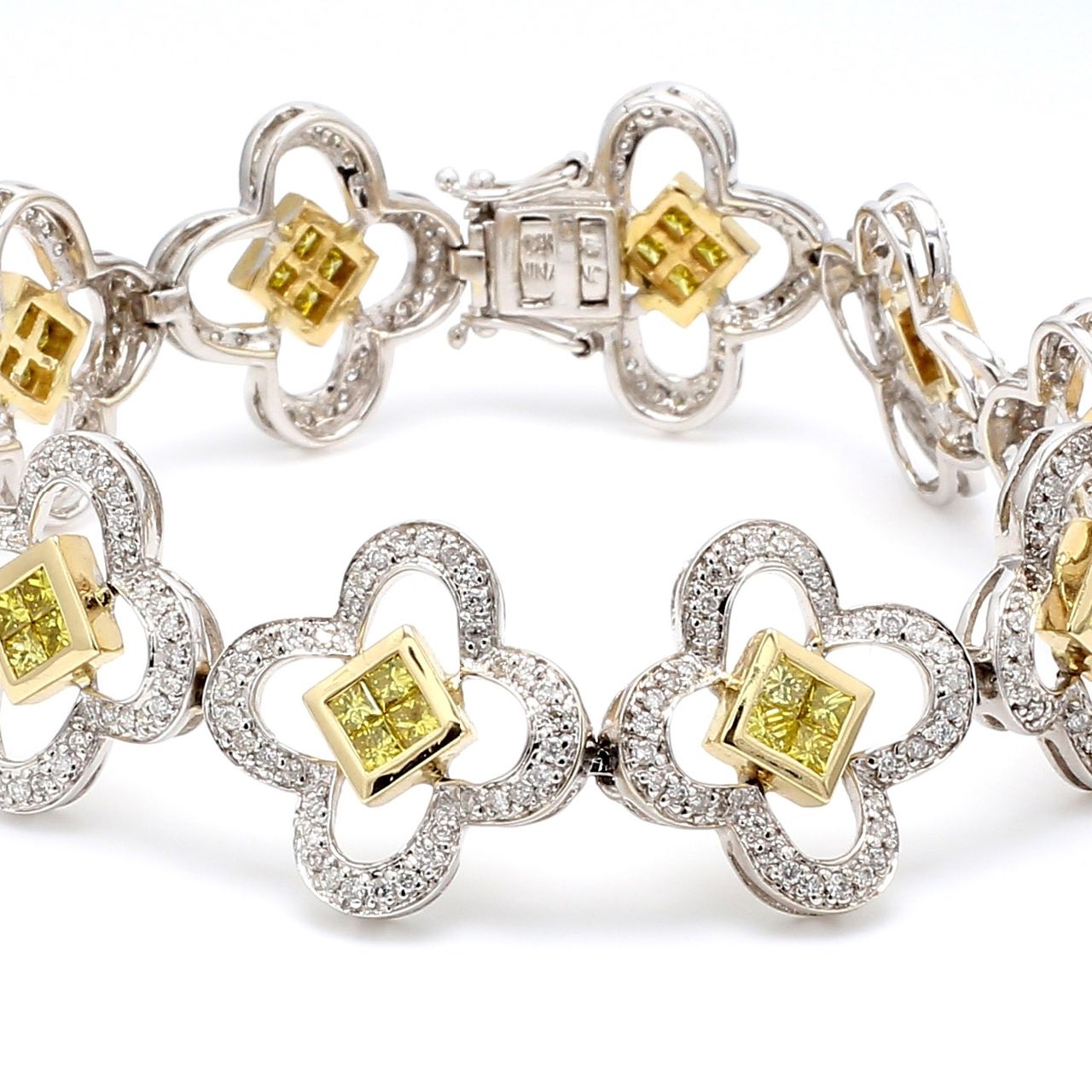 Flower design link bracelet in 2-tone with pave set rounds and 2x2 invisible set princess cut diamonds.  D4.75ct.t.w.